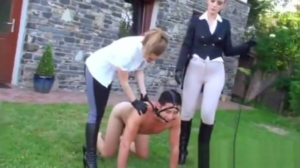 Blonde in equestrian gear commands her pony on the grassy lawn on adultfans.net