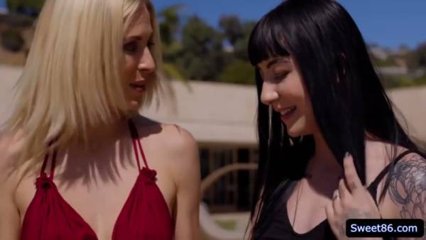 Gothic woman in black stockings embraces her blonde lover outdoors on adultfans.net