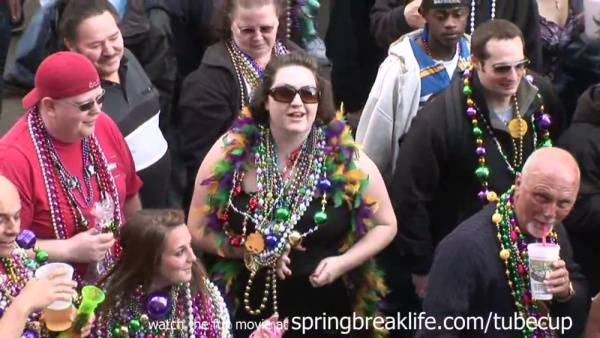 MILF flashes her large breasts during Mardi Gras street celebration on adultfans.net