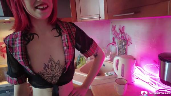 Tattooed redhead in plaid school uniform gives intense oral in the kitchen on adultfans.net