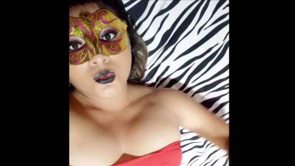Brunette MILF stuns in red top and ornate mask on zebra print backdrop on adultfans.net