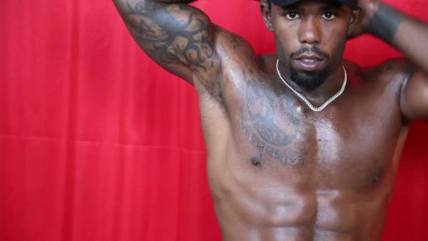 Muscular black man in cap gives handjob commands with dominant presence on adultfans.net