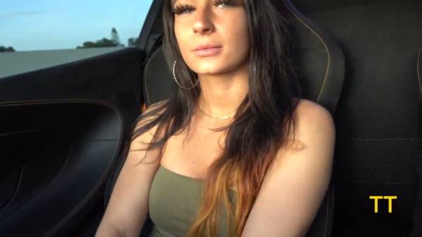 Alessia Luna kneels before Teddy Tarantino's McLaren for a rough outdoor handjob on adultfans.net