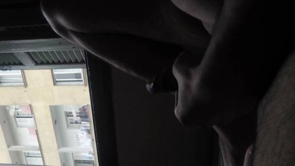 Alone in a hotel room, a figure masturbates at the window watched by an elderly neighbor on adultfans.net