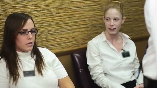 Two young women explore intimacy in a candlelit study after hours on adultfans.net