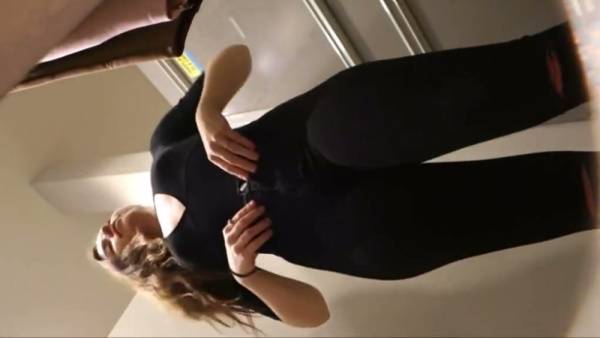 Slender brunette in tight pink leggings caught on camera during a fitting session on adultfans.net