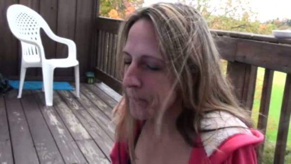 Woman gives deep throat blowjob to man on wooden deck outdoors on adultfans.net