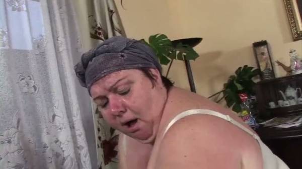 BBW woman pleasures herself with an anal toy before welcoming a man on the couch on adultfans.net