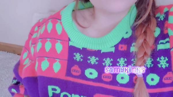 Young woman in festive sweater explores herself on the carpet on adultfans.net