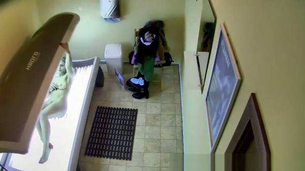 Blonde walks through solarium with hairy pussy caught on hidden cam on adultfans.net