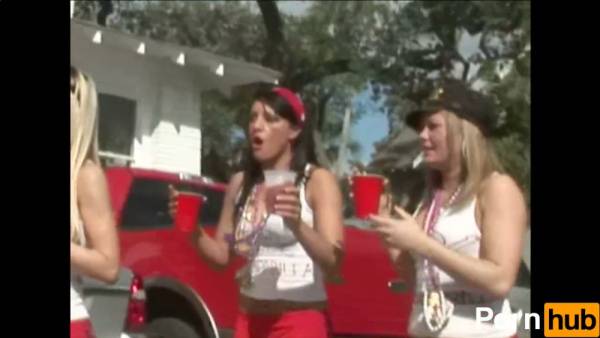 Two young lesbians flash bare skin and grind in public during a wild street party on adultfans.net