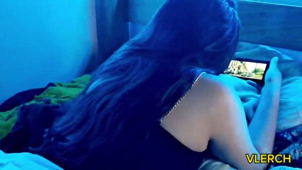 Young Latina teen caught watching steamy content on her phone in blue-lit bedroom on adultfans.net