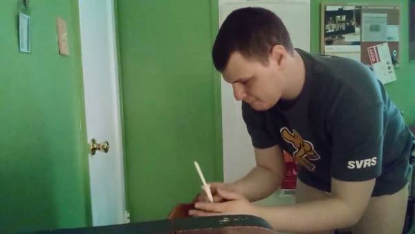 Man prepares an enema in diaper briefs with buttocks exposed in a green room on adultfans.net