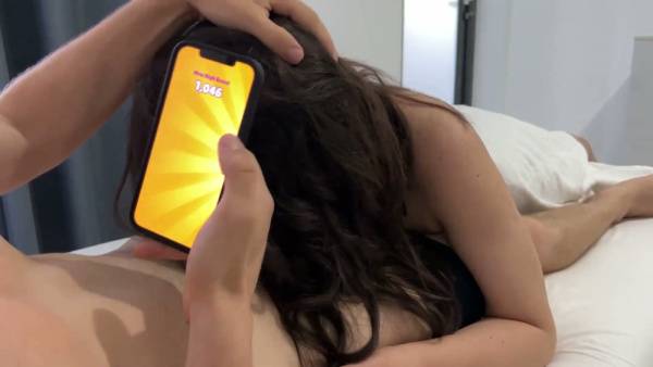 Curvy brunette gives her boyfriend a blowjob while he plays games in bed on adultfans.net