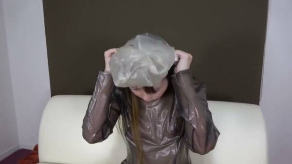 Japanese woman in shiny PVC dress explores breathplay and self-bondage on white leather couch - Japan on adultfans.net