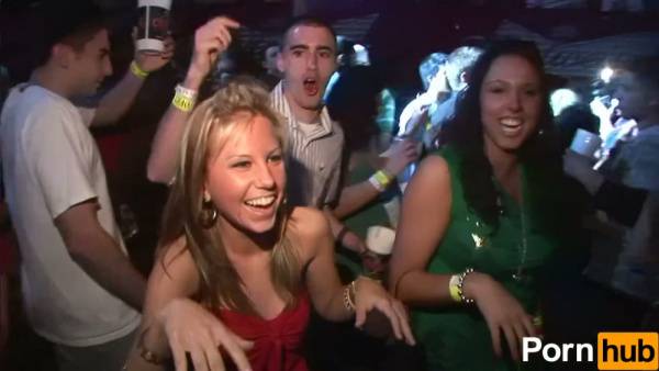 Two wild party girls in lingerie tease the crowd at a neon-lit nightclub on adultfans.net