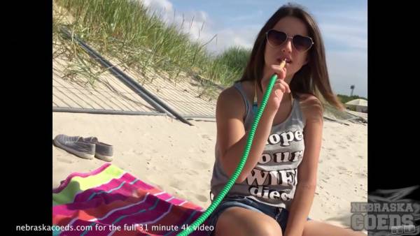 Amateur brunette MILF enjoys sunny beach moments before intimate encounters on adultfans.net