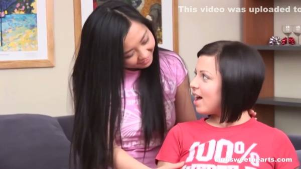 Two Asian lesbians explore each other with fingers and anal toys on the couch on adultfans.net