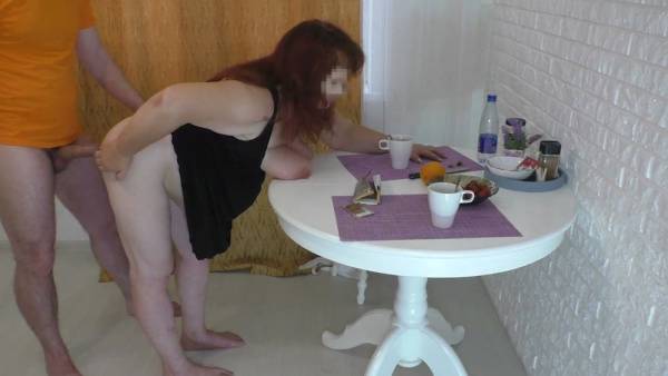 Voluptuous redheaded MILF takes a well-endowed man deep in anal on a white table on adultfans.net