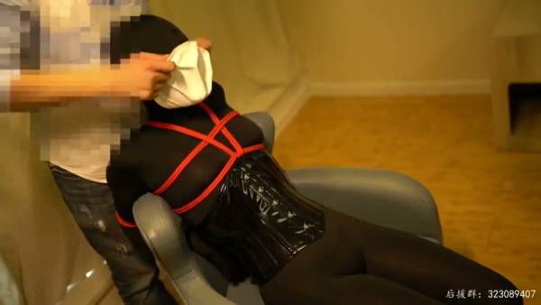 Black latex and red rope bondage session under warm light with Chinese character motif - China on adultfans.net
