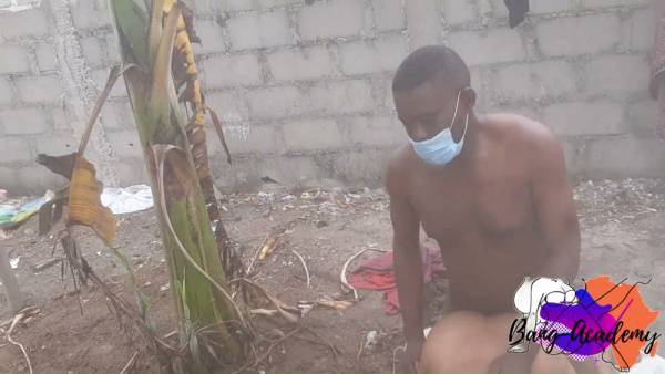 Dark-skinned couple embraces passionately on the dirt ground beneath open skies - Nigeria on adultfans.net