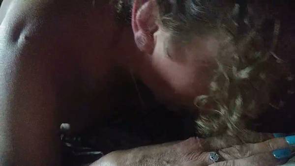 MILF with curly brown hair takes him deep in the dim living room on adultfans.net