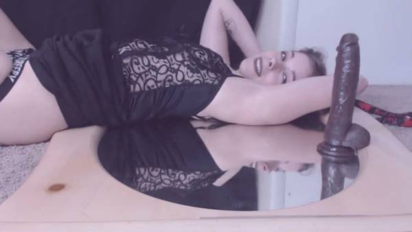 Hairy solo girl rides a thick black dildo in front of a round mirror on adultfans.net