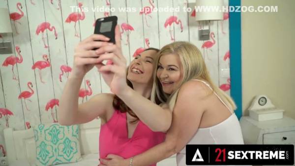 Mature lesbian lovers share passionate cunnilingus under pink flamingo wallpaper on adultfans.net