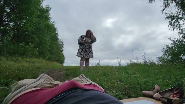 Chubby blonde in knee socks gives outdoor footjob in wooded clearing on adultfans.net