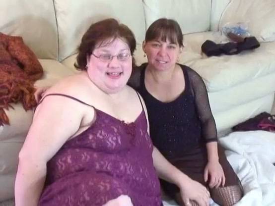 Curvy glasses-wearing woman pleasures her partner with a strapon in intimate setting on adultfans.net