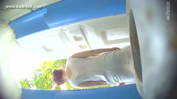 Two blonde women caught on hidden camera as one begins to urinate in a blue-tiled room on adultfans.net
