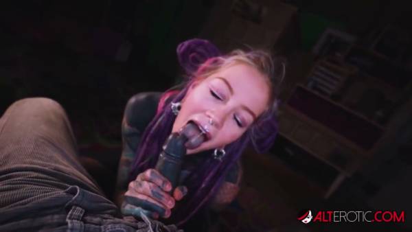 Tattooed woman with purple dreadlocks gives oral to a dark-skinned man in POV on adultfans.net