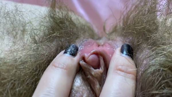 Woman with natural curly pubic hair reveals her clitoris through white lace lingerie on adultfans.net