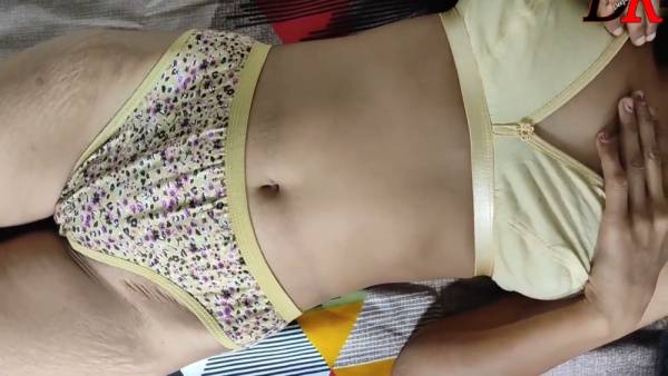 Dark-skinned woman explores herself on a patterned bedspread - India on adultfans.net