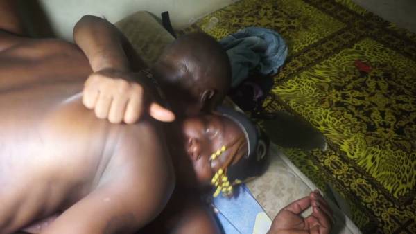 Two muscular black men share an intense bedroom encounter on a cartoon-patterned bed on adultfans.net