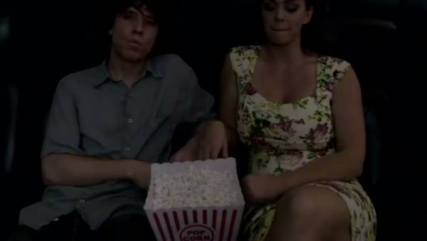 Mature brunette gives a stealthy handjob in a dark cinema on adultfans.net