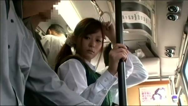Young woman in plaid skirt submits to dominant partner during daring encounter on crowded bus on adultfans.net