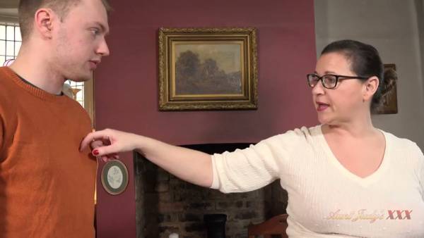 Elegant mature woman in glasses meets her young colleague for an intimate office encounter on adultfans.net