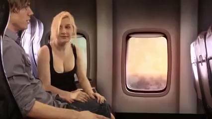 Blonde with big tits gives a discreet handjob to her seatmate on a night flight on adultfans.net