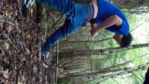 Young man jacks off openly in a sunlit forest clearing on adultfans.net