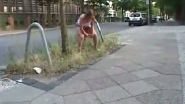 Young woman takes on multiple men in an outdoor gangbang with golden shower on adultfans.net