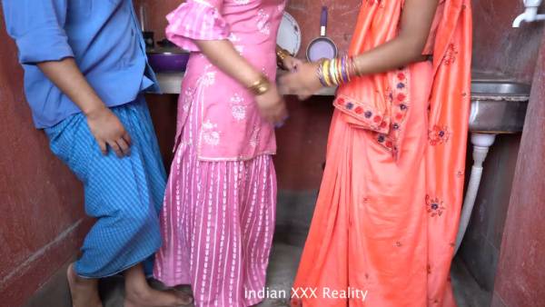 Indian couple shares intimate kitchen moment with a guest in traditional attire - India on adultfans.net