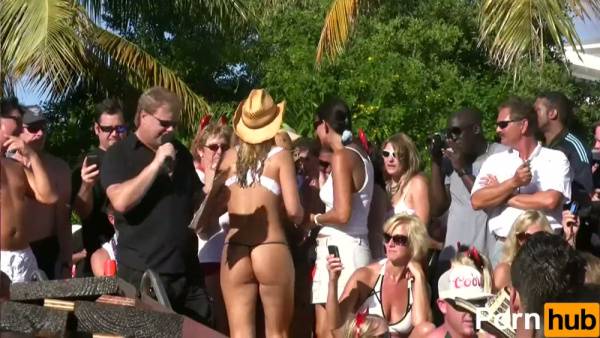 Blonde dancer in white bikini teased by water spray at tropical beach rave on adultfans.net