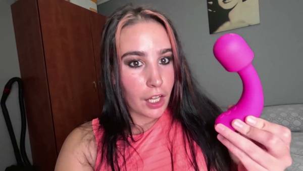 Curvy woman with black-pink hair explores her body with a pink vibrator in bed on adultfans.net