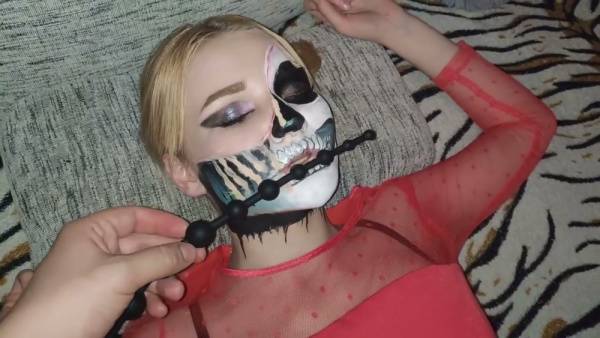 Blonde in red sheer top and skull face paint trains her ass with long anal beads on adultfans.net