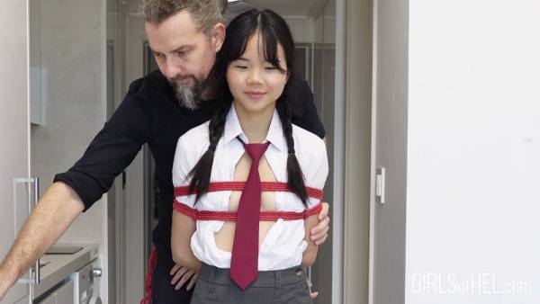 Young Japanese student in school uniform tied up and suspended in a narrow hallway - Japan on adultfans.net