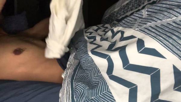 A man teases with a visible bulge in tight blue shorts before bed on adultfans.net