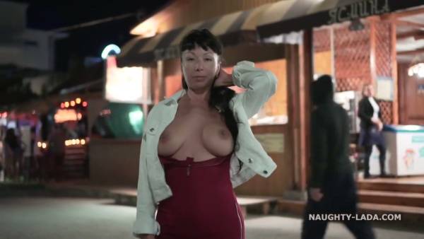 Confident brunette MILF exposes herself on the beach and in public spaces on adultfans.net