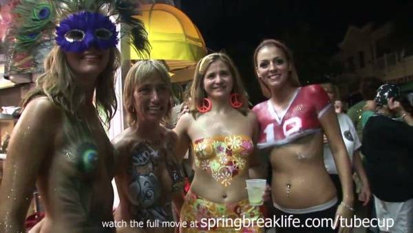 Blonde teens show off elaborate body paint at a Key West festival on adultfans.net