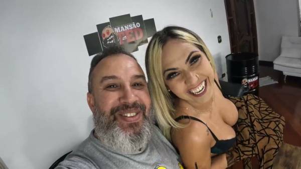Blonde in black lace teases her huge tits at a dimly lit party before closeness with bearded man on adultfans.net
